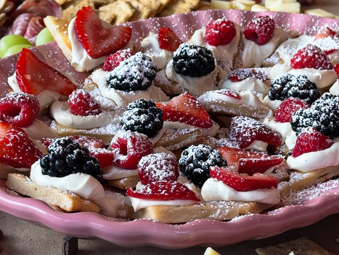 Dessert bites with fruit slices, Very Vanilla Low-Sugar Syrup, and powdered sugar sprinkled on top.